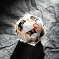 Black Cat Resin D20 Dice – Gold Numbers – This transparent resin D20 dice features gold numbers and a white polyhedral