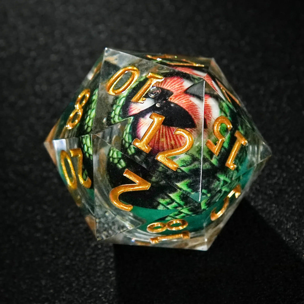 Dragon Liquid Core Dice Set – Gold Numbers – 35mm Eye – A giant 35mm liquid-core resin D20 dice sits on a black