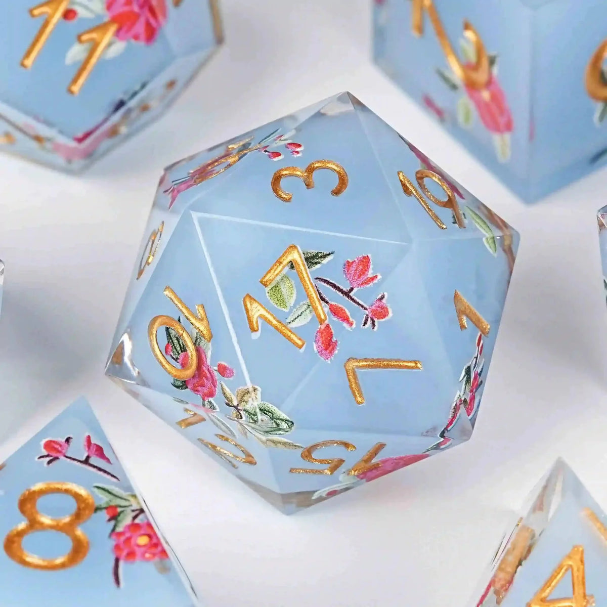 Flower Resin DND Dice Set – Gold Numbers – Light Light – Light blue resin DND D20 dice with a light red floral pattern