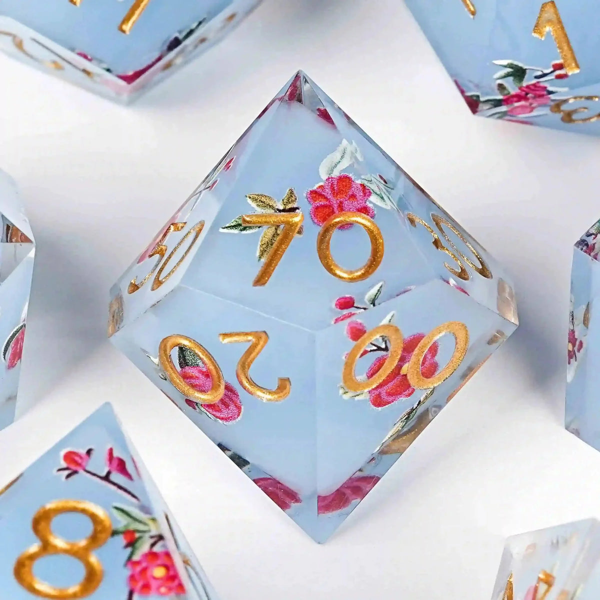 Flower Resin DND Dice Set – Gold Numbers – Light Light – Light blue resin DND D% dice with sharp edges and a light red