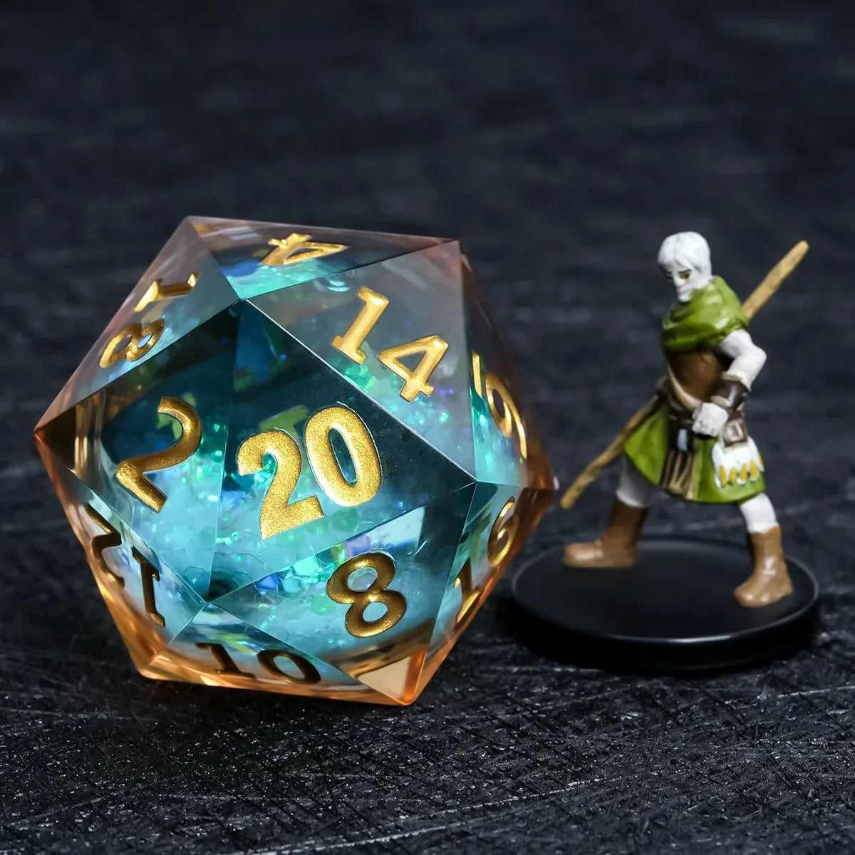 Giant Lettering Liquid Core Dice Set – Gold Numbers – 35mm blue glitter liquid core D20 die with gold engraved numbers