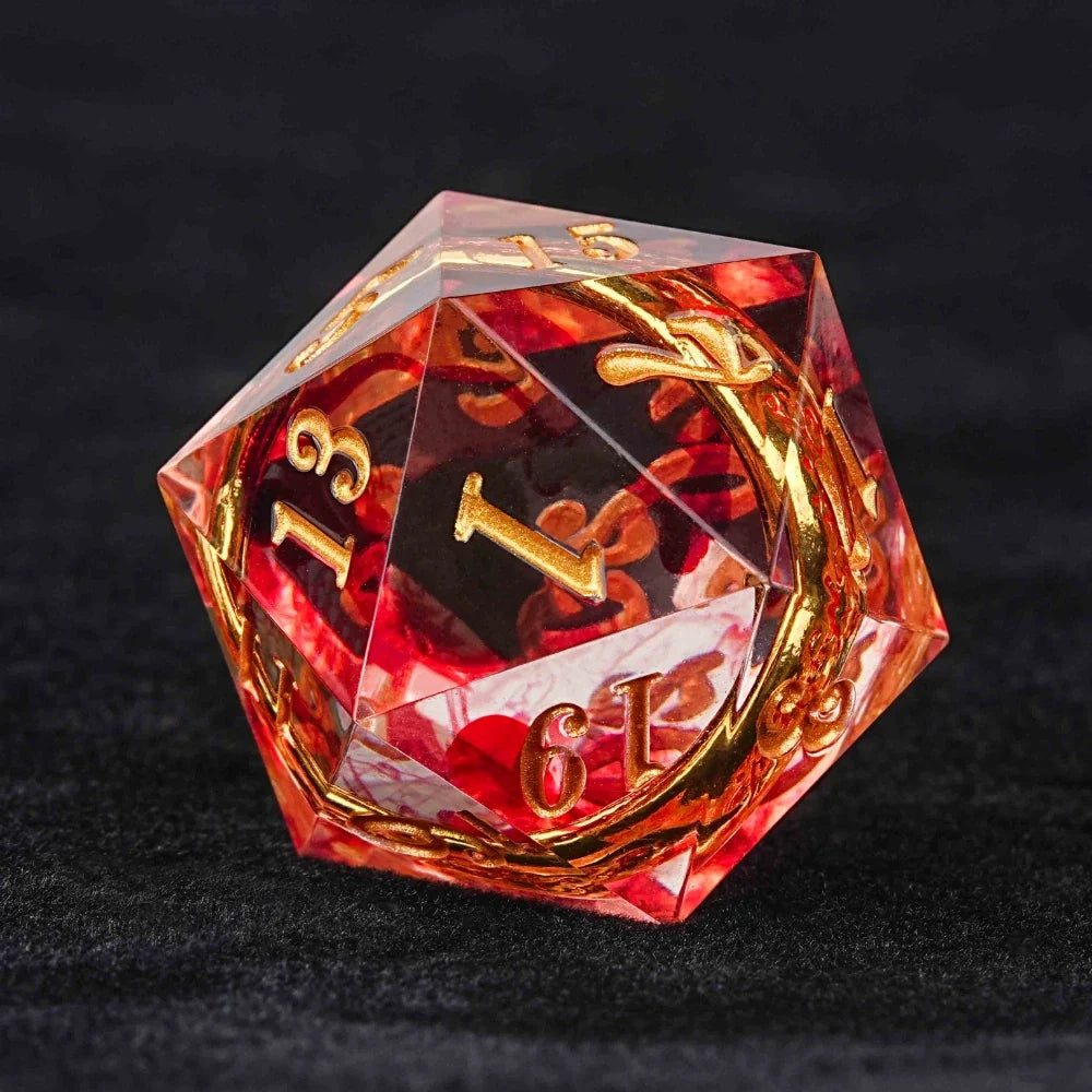 Gold Ring Resin Sharp Edge Dice Set – A red, transparent resin D20 die with sharp edges, containing an engraved gold