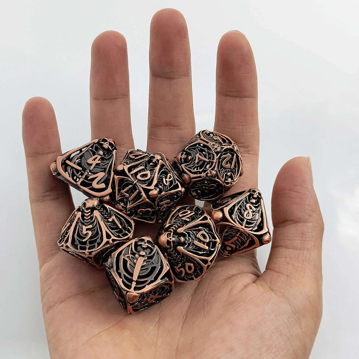 Necromancer Bronze Metal DND Dice Set – This copper metal hollow Necromancer skull dice set is perfect for role-playing