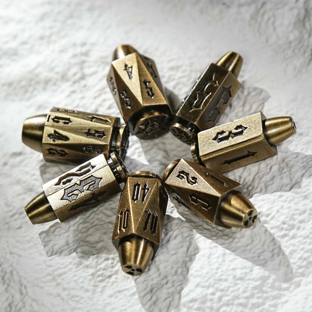 Shaped Polyhedron Metal Bullet Dice Set – Cool antique gold polyhedron DND metal bullet dice, arranged in a circle on