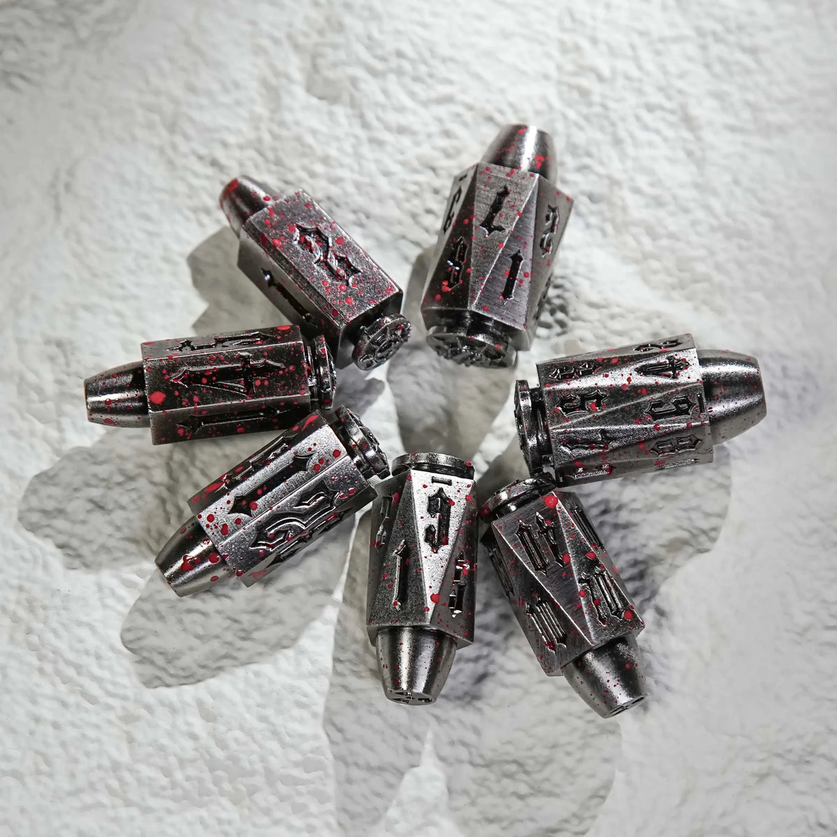 Shaped Polyhedron Metal Bullet Dice Set – A cool set of bloodstained polyhedron DND silver metal bullet dice are placed