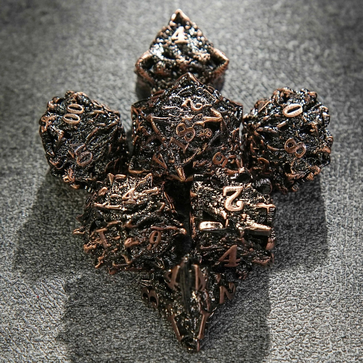 Skeleton Metal DND Dice Set – Dragon Head – Seven copper-colored metal hollow dragon head dice arranged in the shape of