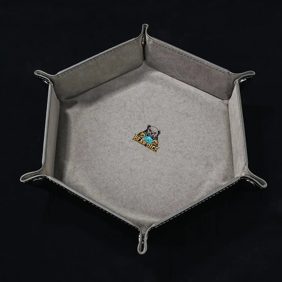 World Cup Dice Tray – Leather – Hexagonal black PU leather RPG dice tray with silver buttons. Gray lining with the logo
